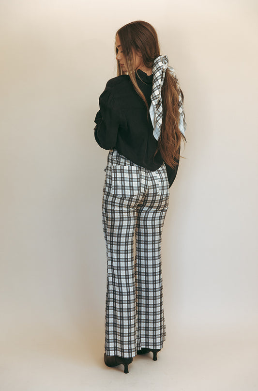 Bridget bell-bottom pants in Retro Plaid, studio back view styled with a black shirt