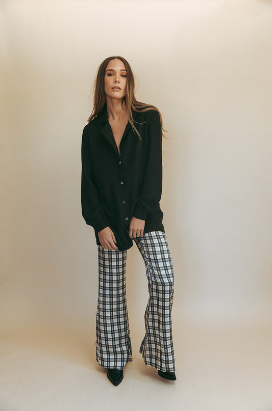 Bridget bell-bottom pants in Retro Plaid, studio front view styled with a black button-up shirt